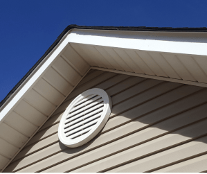 Picture of the outside of a home with a round gable vent