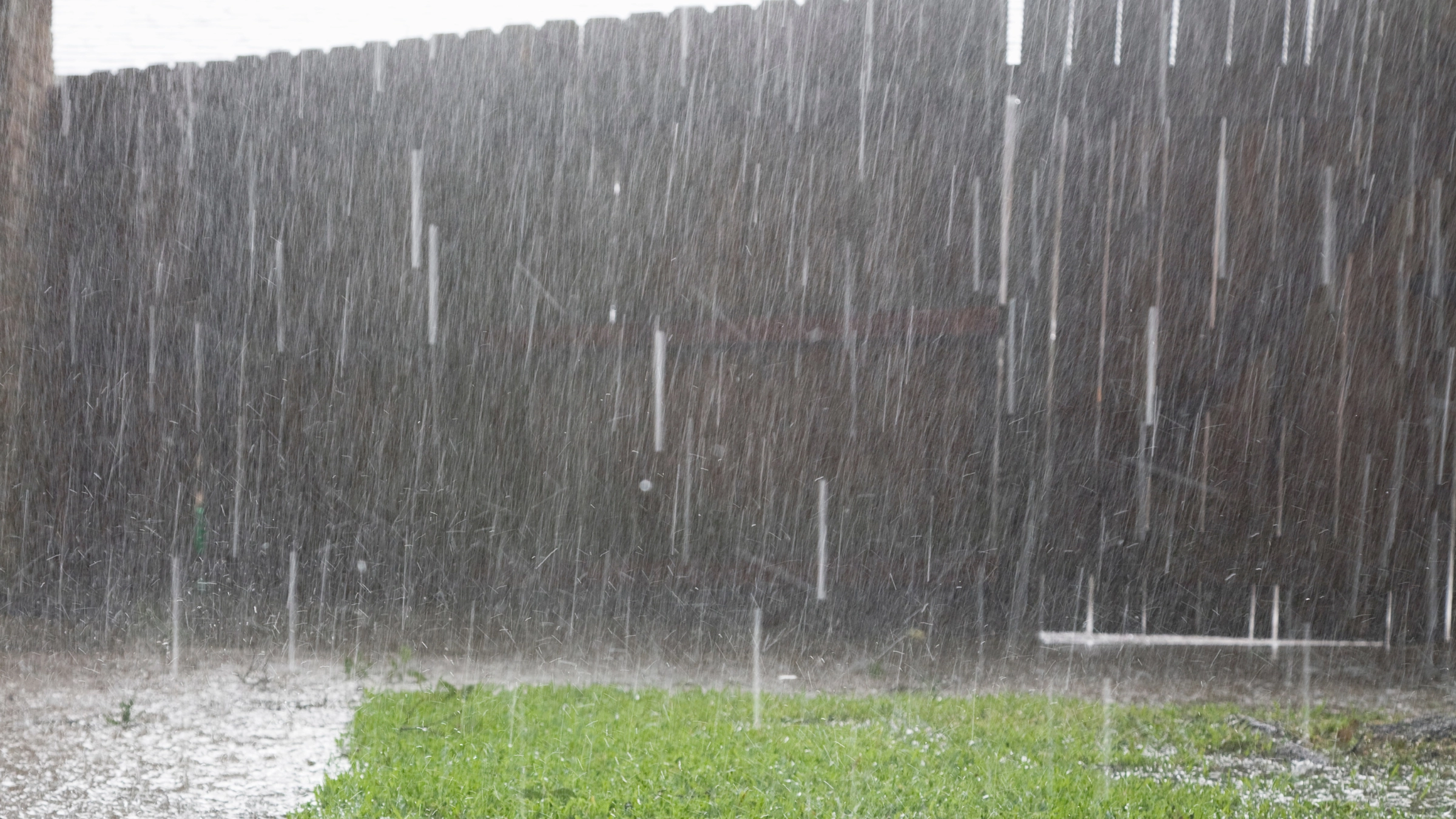 Torrential rain with fence background