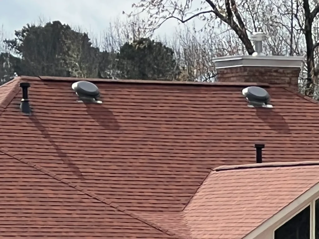 Picture of attic fans on a roof with ridge vent 