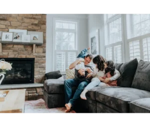 Family Sitting/Playing on Gray Sofa